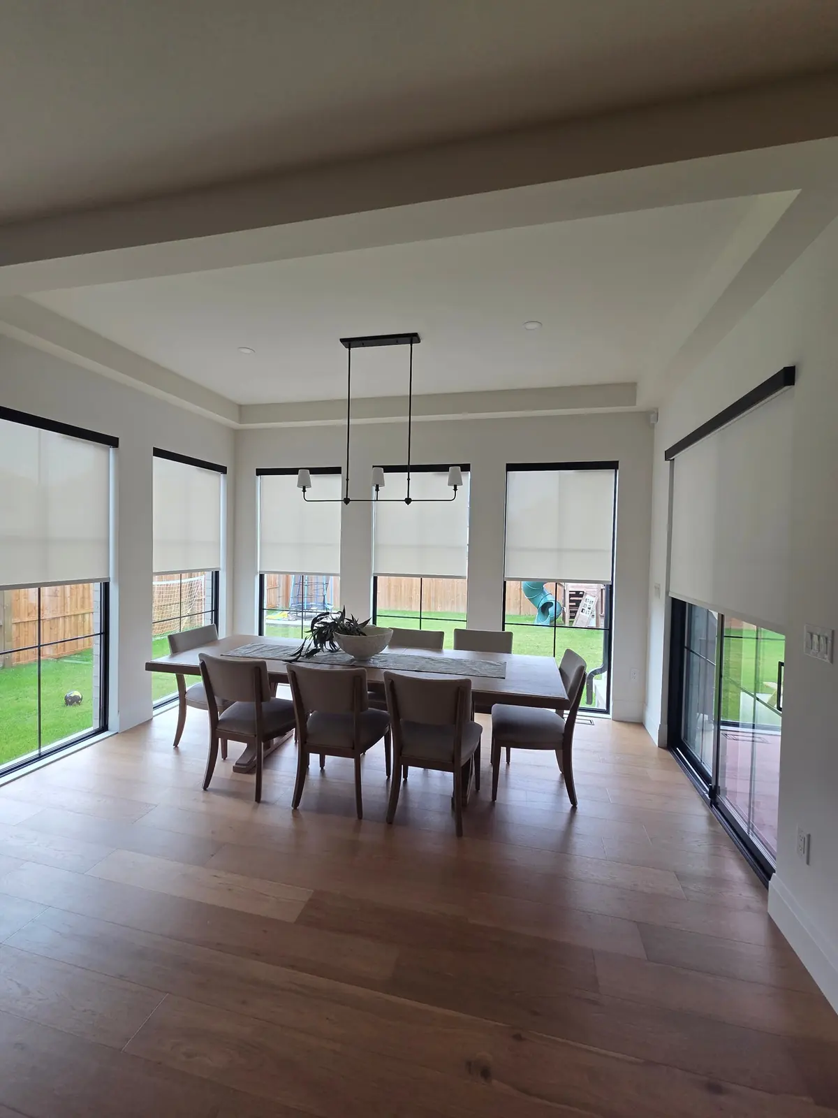 Dining room with screen roller shades and black cassettes